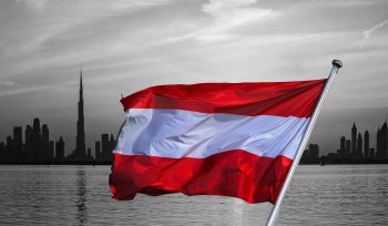 austrian flag over ubai skyline